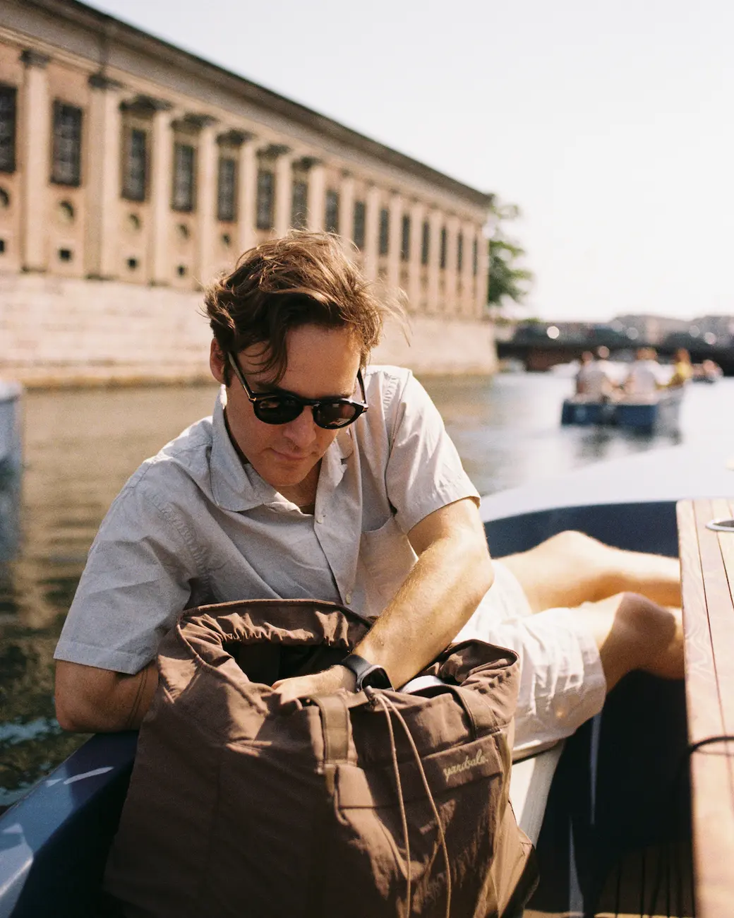 An image of a person in a boat looking into a bag