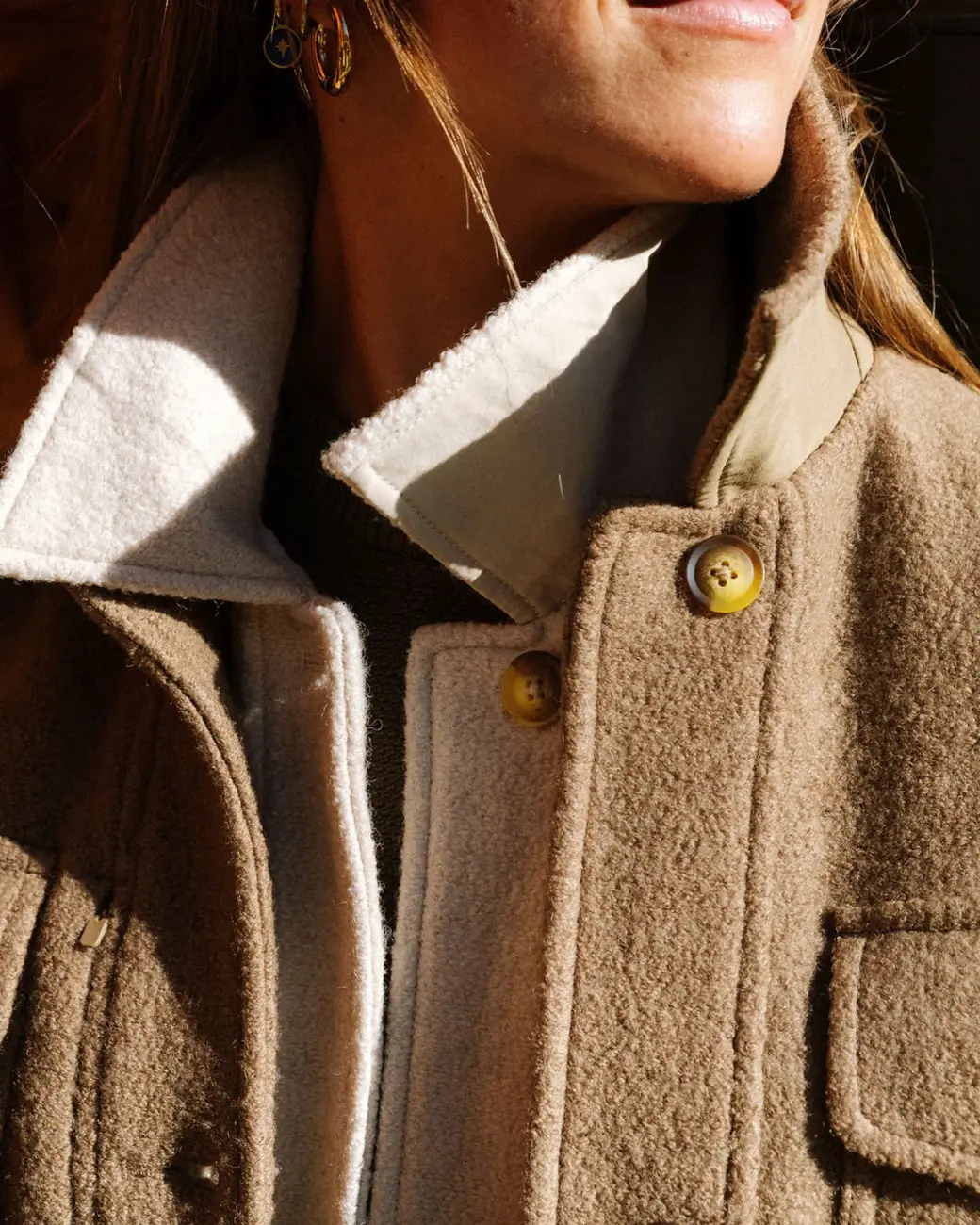 A skier wearing 2 sport coat jackets
