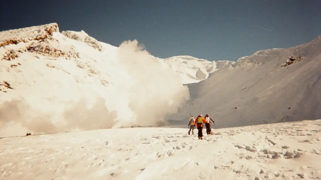 An image of a group of people walking on a snowy mountain