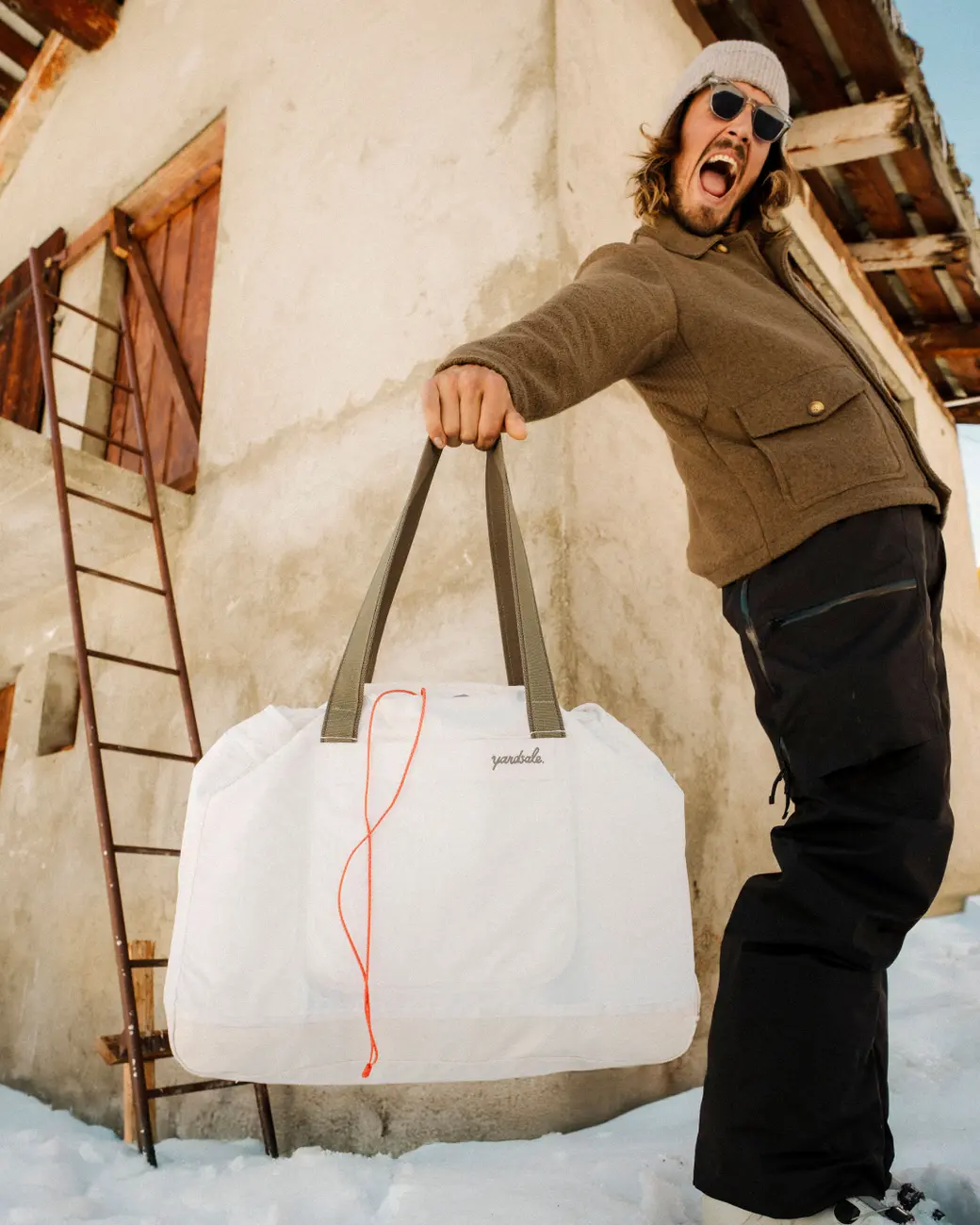 An image of someone holding a bag out in front of them