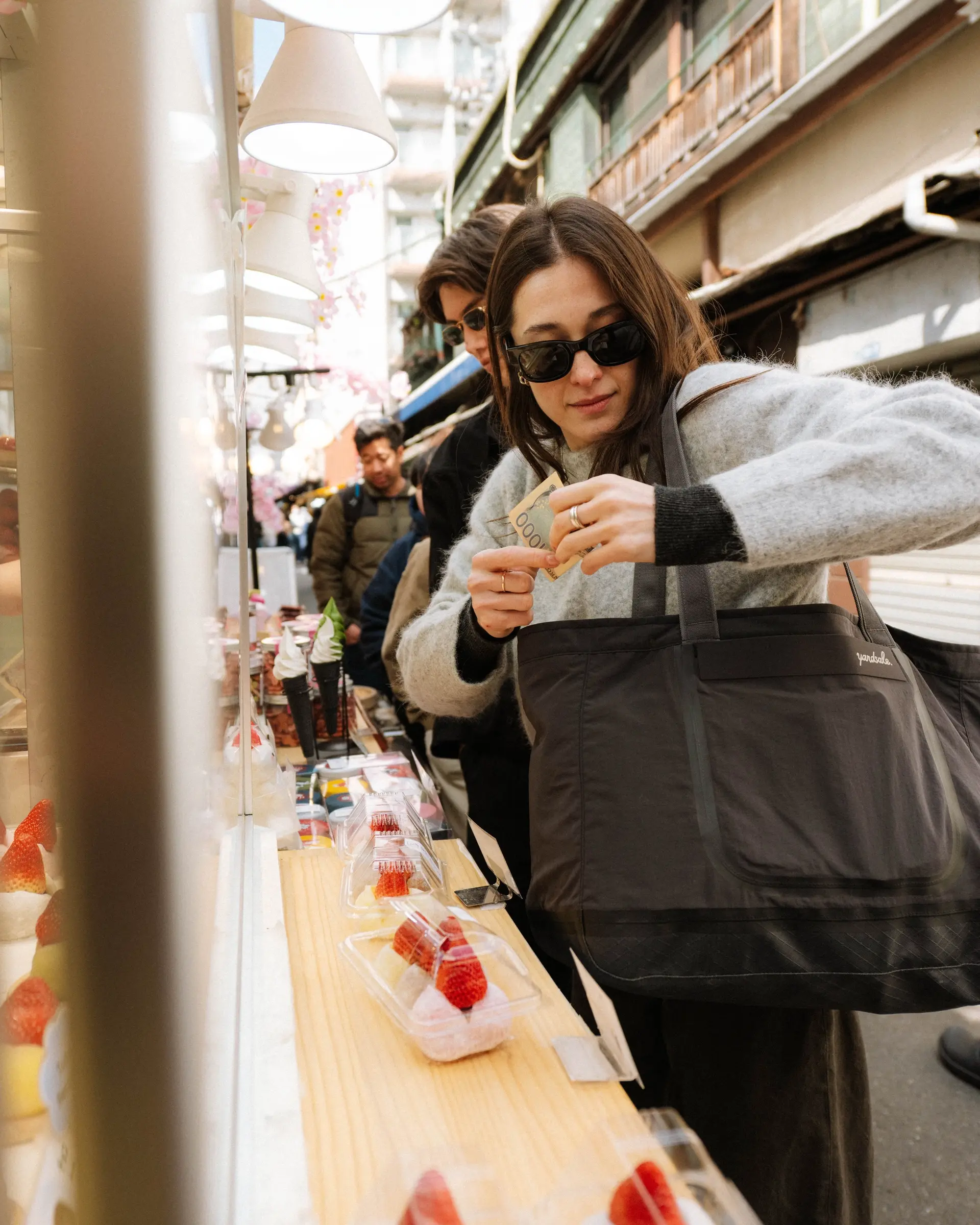 An image of a woman holding a 20L Day Bag in Tokyo