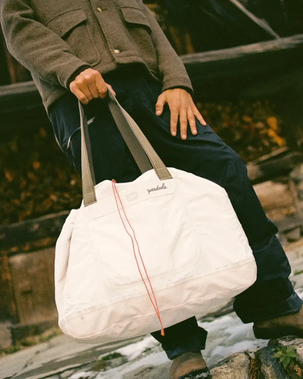 An image of a man holding tote bag