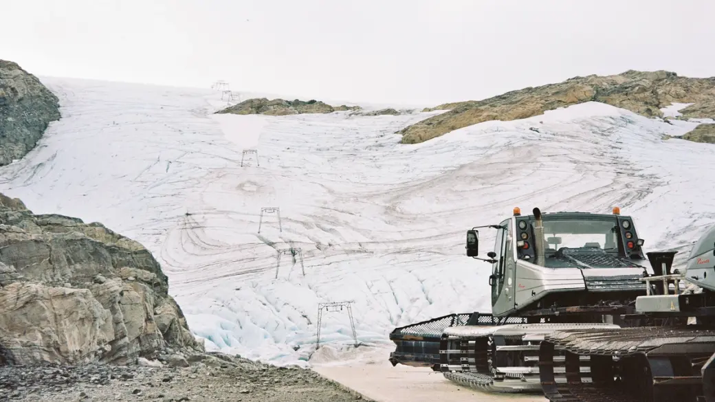 An image of a snow cat near a ski hill