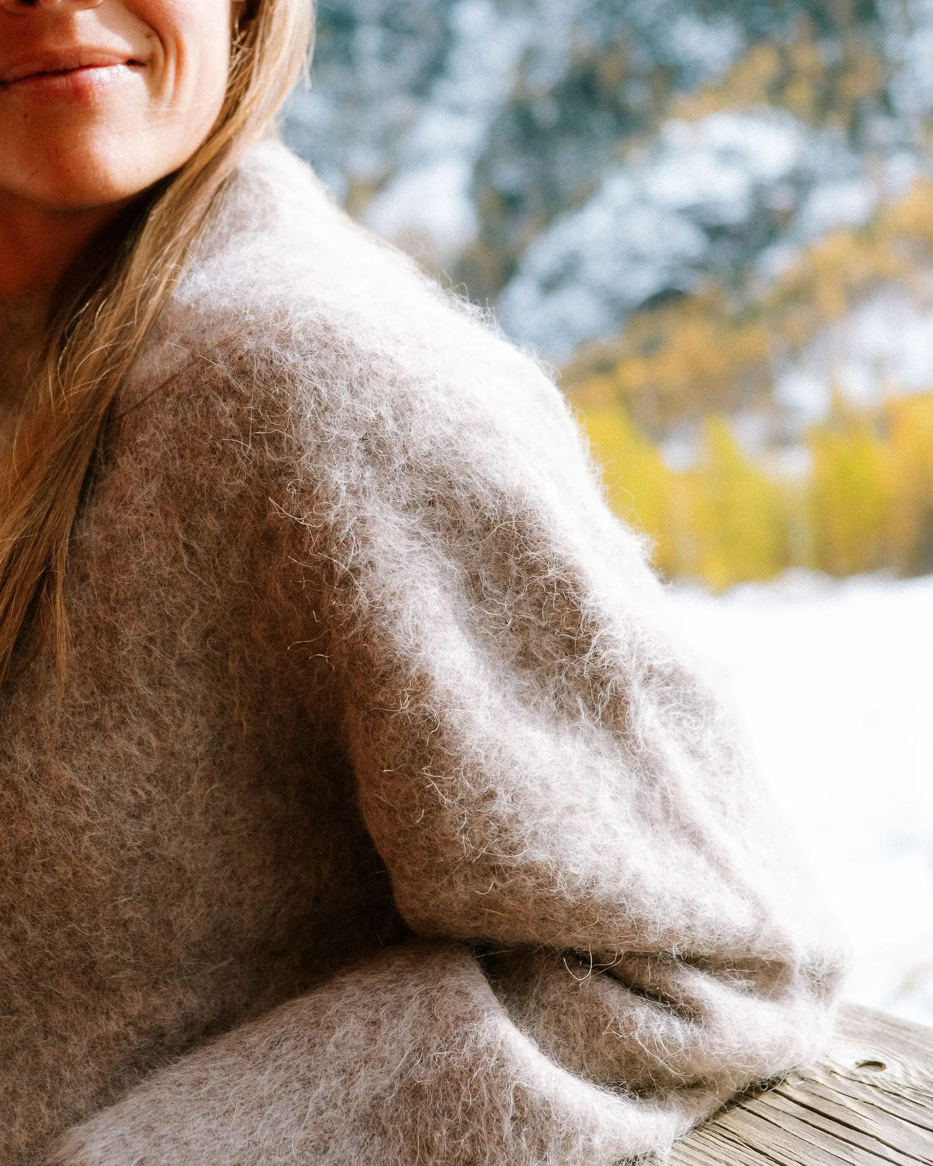 An image of a woman in a cozy alpaca sweater
