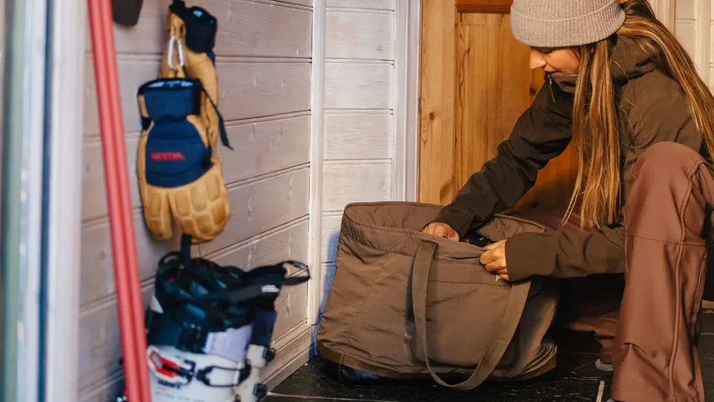 A woman next to some ski gear