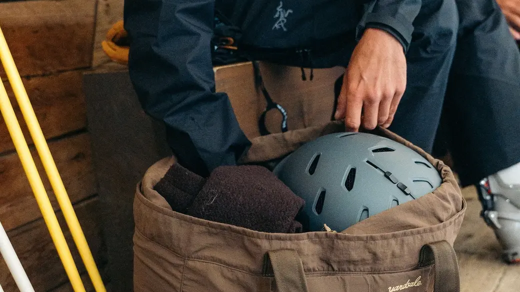 Man reaching into a brown Day bag