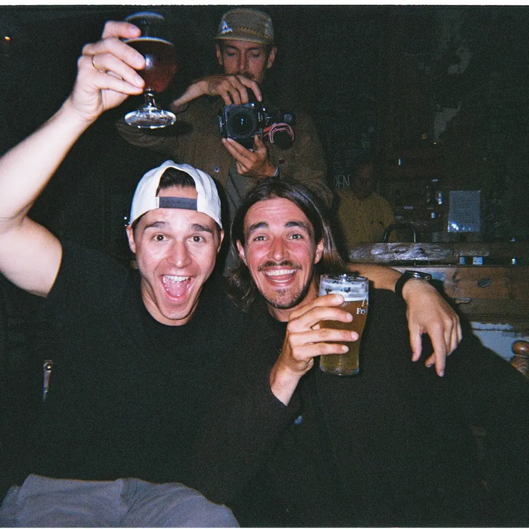An image of two people raising beer glasses