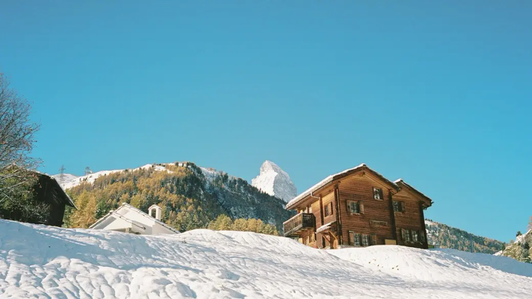 An image of a snow cat near a ski hill