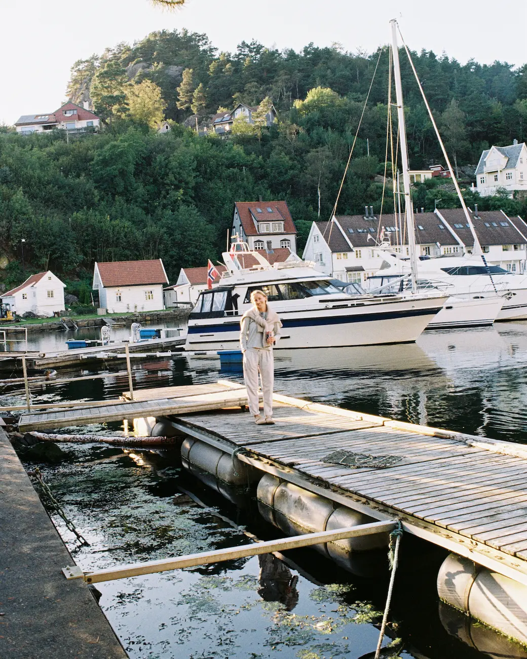 An image of a person standing on a boat dock