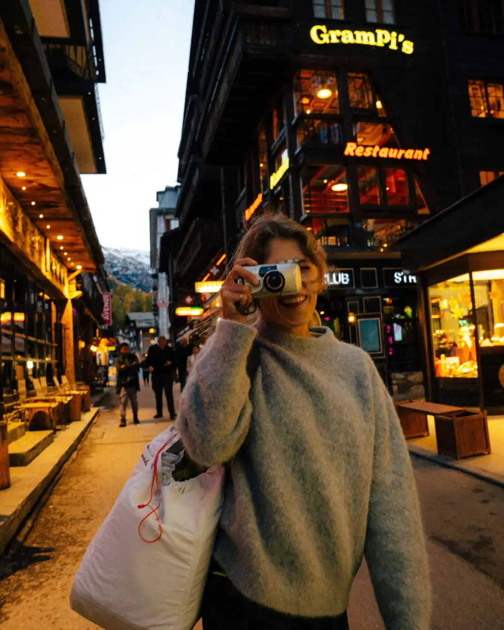 An image of a woman in town with an alpaca wool sweater on