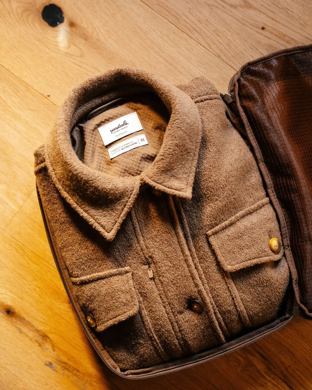 An image of a coat inside of a packing cube