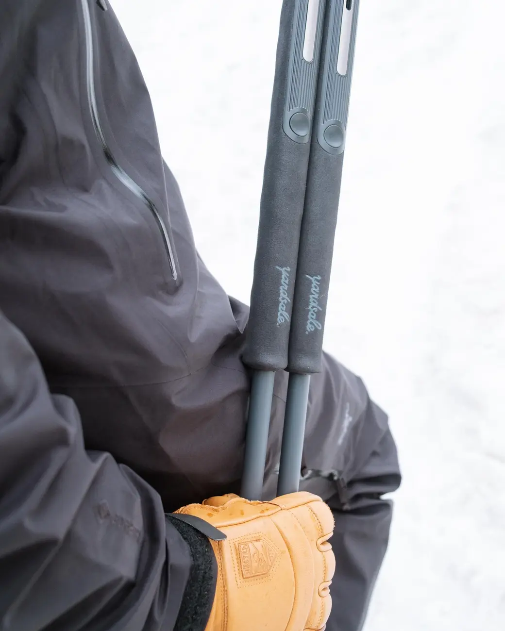 An image of ski poles with long goam grips in someone's hands