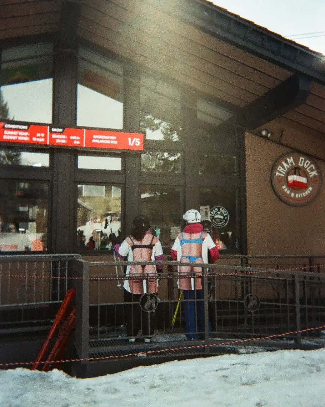 An image a of two people at a ski resort lodge